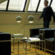 Tecnolumen Beton Pendelleuchte Trabant 1 drehbar mit Linse in modernem Wohnzimmer-Design.
