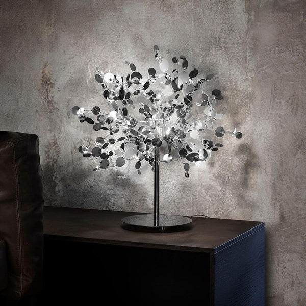 Terzani Argent Design-Tischlampe aus Edelstahl mit schimmernden Metallscheiben auf dunklem Tisch
