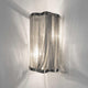Terzani Atlantis Wandlampe mit drapierten Nickelkette und schimmerndem Licht für lebendige Energie.