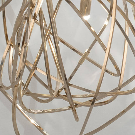 Terzani Doodle table lamp made of golden, handcrafted metal strips forming dynamic shapes.