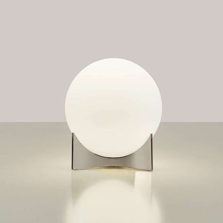 Terzani Oscar design table lamp on a table, with soft, diffused light and a modern design.
