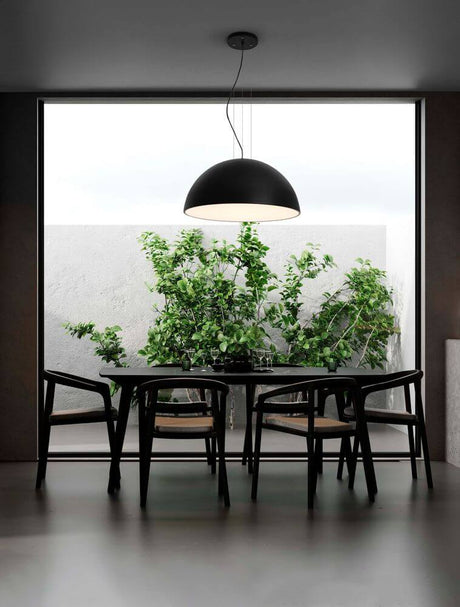 Tholos pendant light E27 3-light Black, White above a dining table with plants in the background.