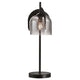 Tischlampe Boshi mit moderner Glaskuppel und elegantem schwarzem Design auf einem stabilen Sockel.