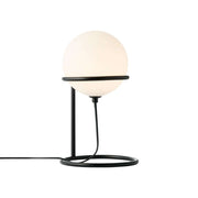 Wilson table lamp with elegant black metal frame and round, adjustable glass shade for a cozy atmosphere.