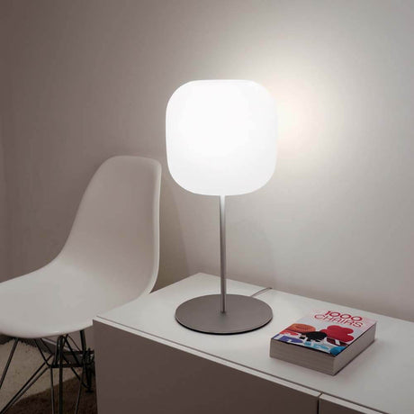 Casablanca Tischleuchte Murea Ø 25cm Alu auf einem modernen Sideboard neben einem weißen Stuhl