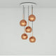 Tom Dixon Copper 5er Pendelleuchte Ø 25cm mit hochreflektierenden Kupfer-Lampenschirmen.