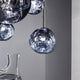 Tom Dixon Melt LED Trio Pendelleuchte 3er Mobile Ø 81cm mit hypnotischem, schmelzendem Glasdesign.