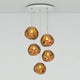 Tom Dixon Melt Mini LED Pendellampe mit fünf schmelzenden Glaskugeln in Kupfer, modernes Design für stilvolle Beleuchtung.
