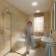 Moderne Badezimmer mit Deckenspot Puk Turn Up- & Downlight, Dusche und einer lächelnden Frau.