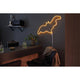 LED-Neonlicht in Form einer Fledermaus, orange leuchtend, dekorativ im modernen Raum installiert.