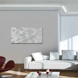 Moderner Wohnraum mit grauer Wand und abstrakter Wandkunst auf Leinwand, elegantes Sofa und stilvolle Möbel.