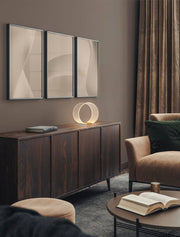 Valentin LED table lamp Ø 28cm 3000K Gold on a stylish sideboard in a modern living space.