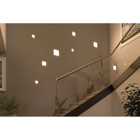 VariFit LED recessed wall and ceiling panel Veluna Satin on a staircase wall, atmospheric lighting design.