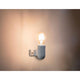 Wandlampe SERA Weiß mit leuchtender Glühbirne an einer Wand montiert