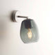 Casablanca Wandleuchte Bagan Aluminium mit grauem Lampenschirm an der Wand.