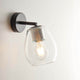 Casablanca Wandleuchte Bagan Aluminium an der Wand mit Glaslampenschirm und Glühlampe.