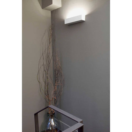 Wall light EACO-2 2-light White on a wall with decoration.