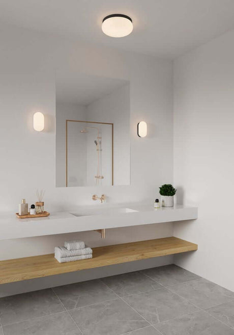 Vue moderne de salle de bains avec l’applique murale Foam IP44 et un aménagement minimaliste.