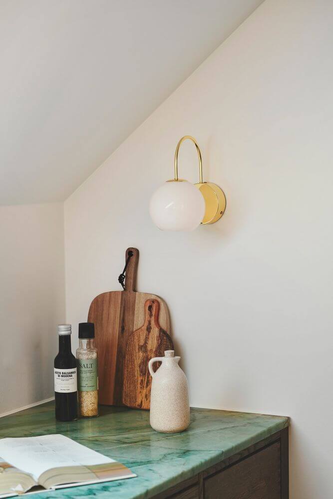 Wandleuchte Franca an einer Wand über einer Küchentheke mit elegantem Design und mundgeblasenem Glas