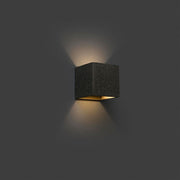 KAMEN wall light in concrete look with modern design and a warm light effect.