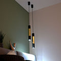 s.luce Hängelampe Crutch in modernem Design mit dekorativem Zylinder über einer Couch