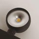 Close-up of the s.luce Beam LED lamp with silver reflector surface and yellow LED element.