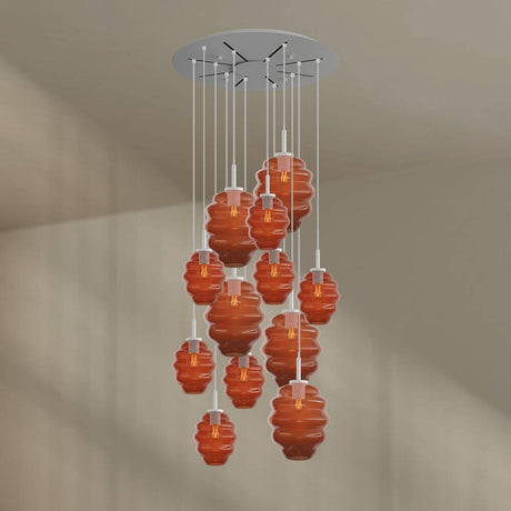 s.luce Echos 12-flammige Pendelleuchte mit mundgeblasenen Glaskörpern in Braun und Klarglas.
