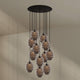 s.luce Echos Galerieleuchte 12-flammig Ø 80cm Baldachin Ø 25cm mit organischen Glaskörpern in Braun und Rauch.
