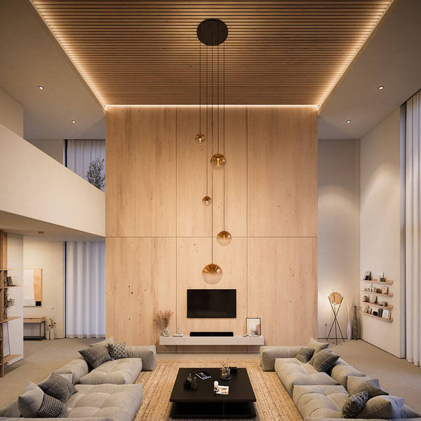 s.luce Orb Lámpara de galería Modular de 5 luces en un elegante salón sobre una acogedora zona de sofás.