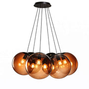 s.luce Orb Cluster multi-pendant light, 7-light, 7x20 cm in a modern design with amber-colored glass spheres.