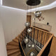 s.luce Orb glass ball pendant light in a modern staircase with elegant wooden stairs.