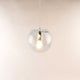 s.luce Orb glass ball pendant light in modern design with clear glass ball and visible light.