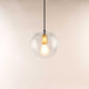 s.luce Orb glass ball pendant light in clear glass ball with warm light.