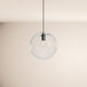 s.luce Orb glass ball pendant light in modern design with clear glass ball and black suspension system.