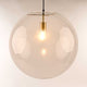 s.luce Orb glass ball pendant light in clear, stylishly hanging with warm light.