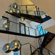 s.luce Orb glass ball pendant light in a stylish staircase with modern steps and glass railings
