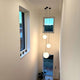 s.luce Orb glass ball pendant light in a modern staircase with large windows.