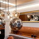 s.luce Orb glass ball pendant light in a modern living room, stylishly and elegantly staged.