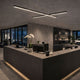 s.luce Oris LED linear lamp office pendant light XL custom-made 2700K above the reception desk in a modern office