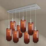 s.luce Velo Esstischlampe mit 8 eleganten Glaskörpern in rötlichem Farbton, modernes Design für stilvolle Räume.