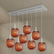s.luce Velo Esszimmerlampe 8-flammig 160cm 2-reihig Ø 20cm chandelier with amber glass shades.