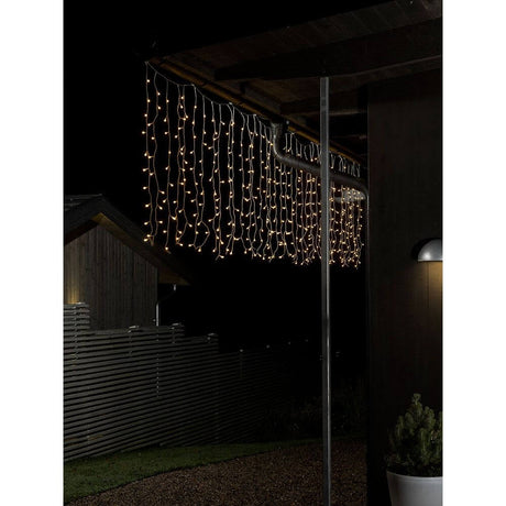 LED Curtain of lights with white globes 200 warm white diodes IP44 hang in the dark and illuminate the night.