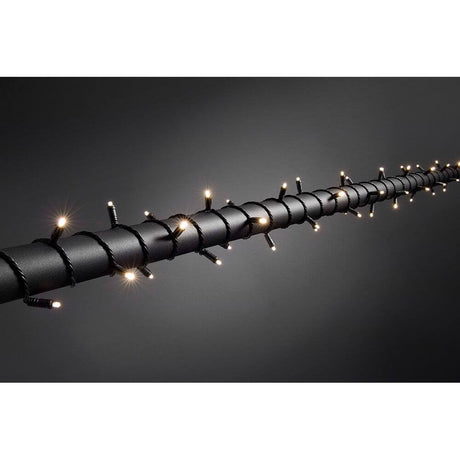 31m Micro LED string lights with 9h timer IP67 120 warm white diodes IP44 on black background