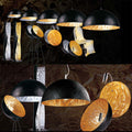 s.luce Blister Pendelleuchte in Schwarz und Silber mit goldener Innenseite, ideal für moderne Innenräume.